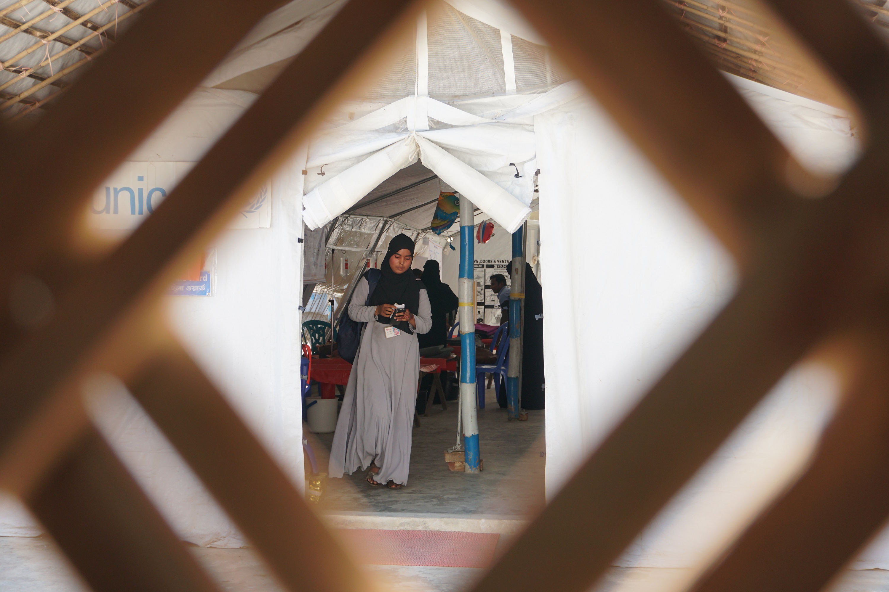 Woman walking out of a health facility - Tatiana Almeida